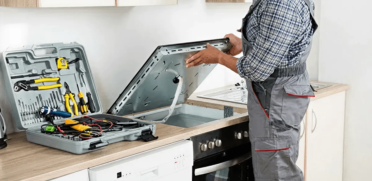 Handyman repairing a cooktop and checking wiring connections in Oakland, CA