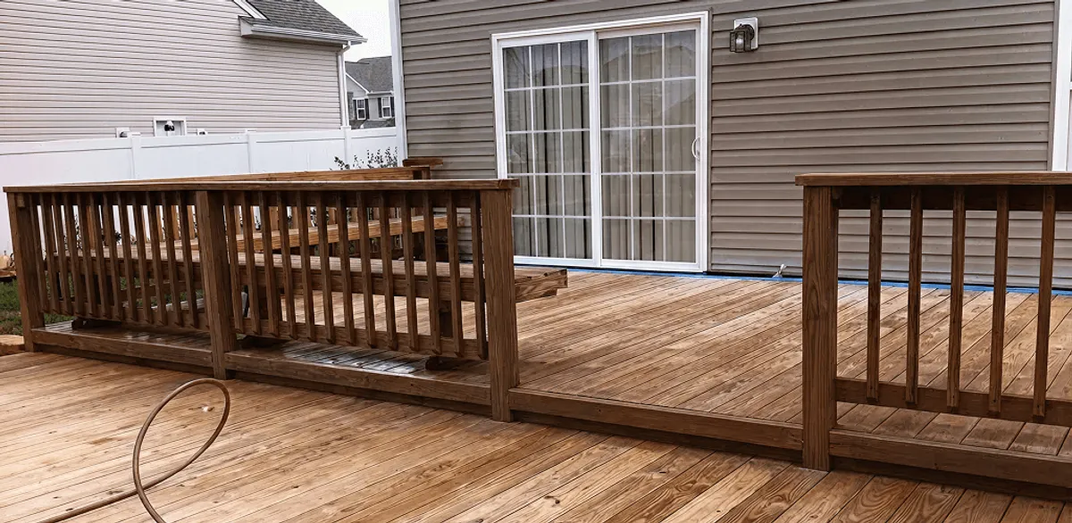 Deck sealing service protecting a backyard wood deck and railings in Oakland, CA