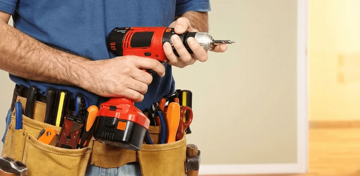 Handyman holding a power drill for home repairs and installations in Oakland, CA