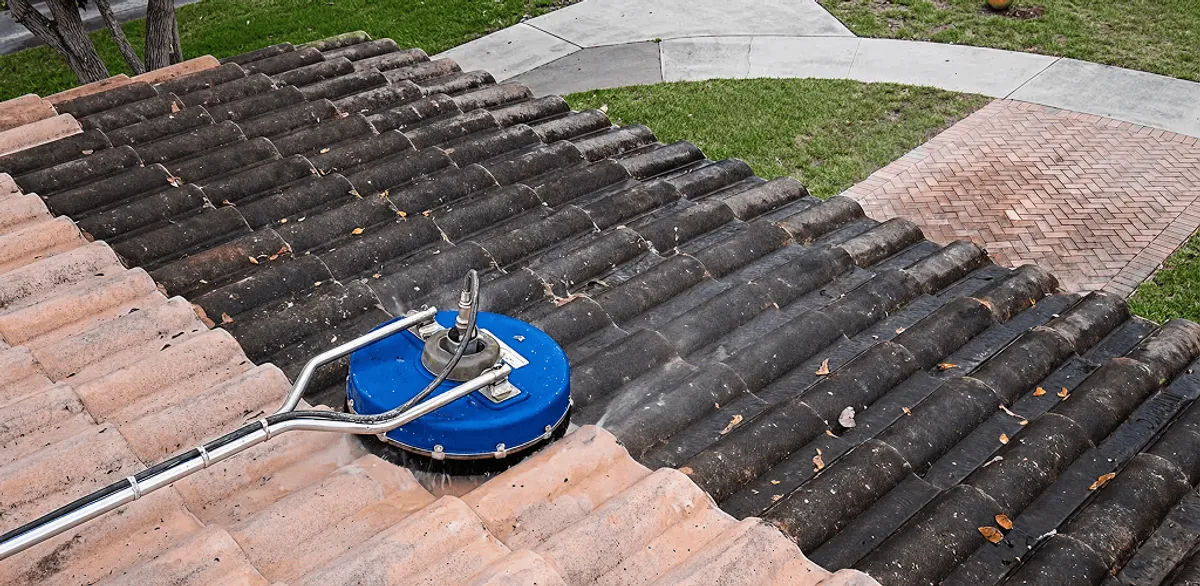 Roof pressure cleaning removing debris and buildup from roof tiles in Oakland, CA