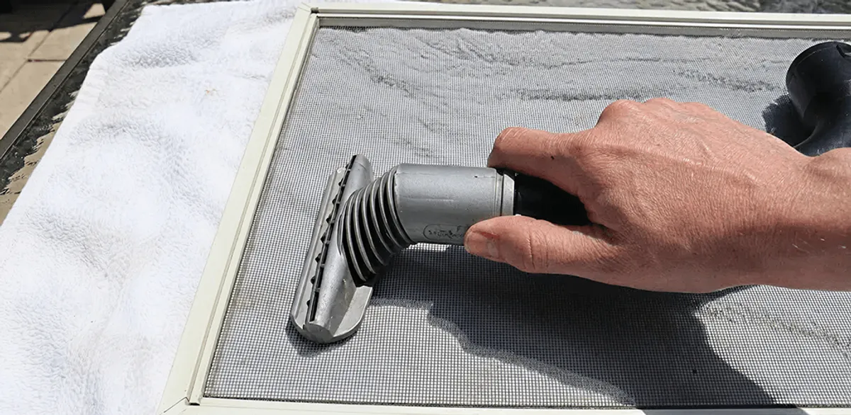 Window screen repair cleaning and fixing a damaged screen mesh in Oakland, CA